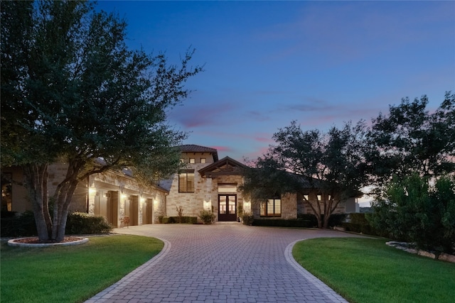 mediterranean / spanish house with a lawn