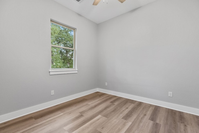 spare room with ceiling fan and light wood-type flooring