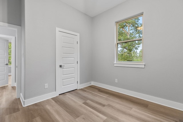 unfurnished bedroom with light wood-type flooring