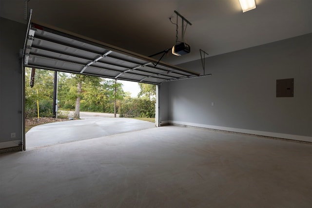 garage with a garage door opener, electric panel, and a carport