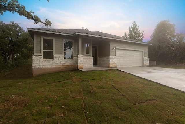 view of front of home with a yard and a garage