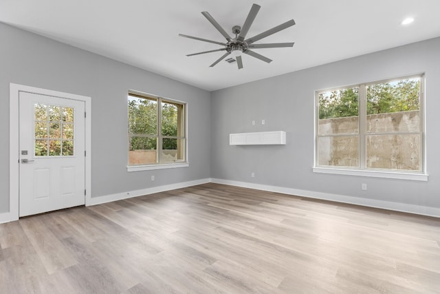 interior space with ceiling fan and light hardwood / wood-style floors