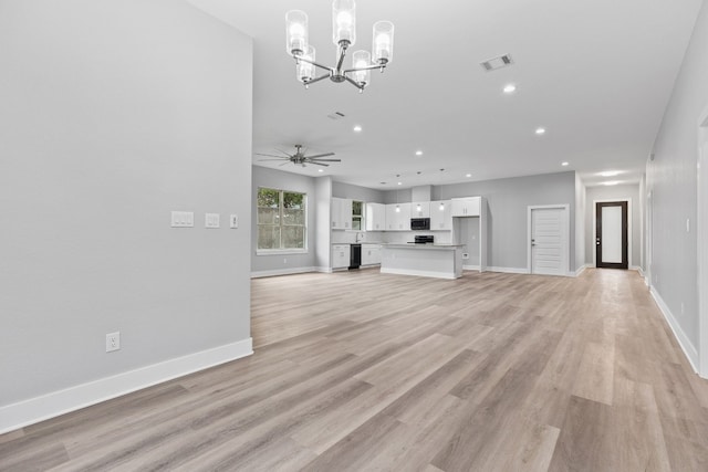 unfurnished living room with ceiling fan with notable chandelier and light hardwood / wood-style flooring