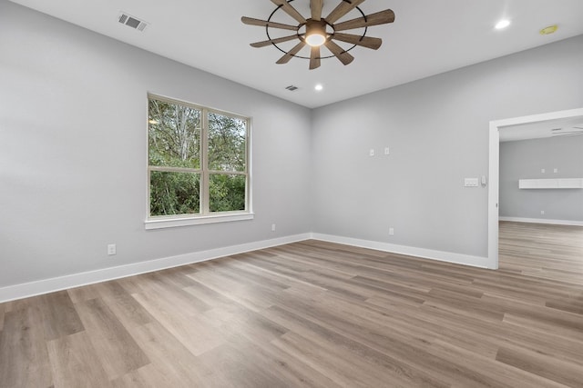 spare room featuring light hardwood / wood-style floors and ceiling fan