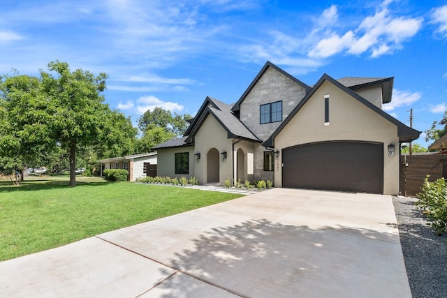 view of front facade with a garage and a front lawn