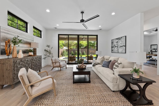 living room featuring ceiling fan and light hardwood / wood-style floors