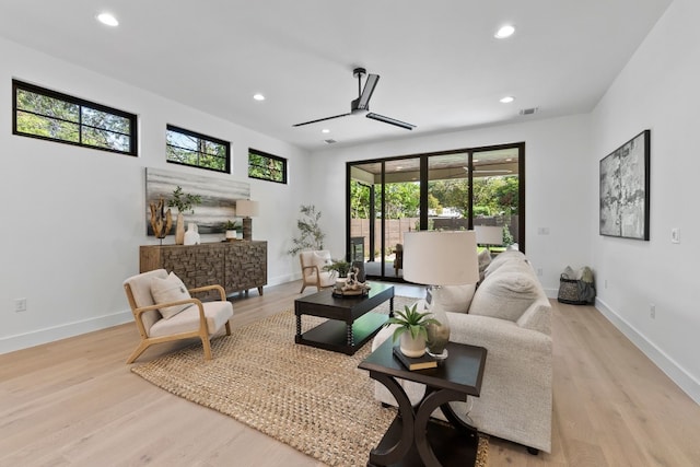 living room with ceiling fan and light hardwood / wood-style floors