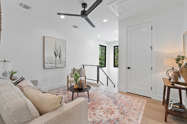 living room with ceiling fan and light wood-type flooring