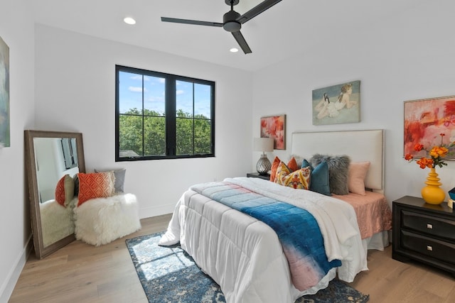 bedroom with ceiling fan and light wood-type flooring