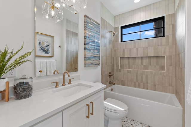 full bathroom with tiled shower / bath, vanity, and toilet