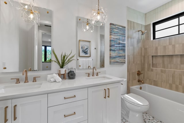 full bathroom featuring vanity, toilet, and tiled shower / bath combo