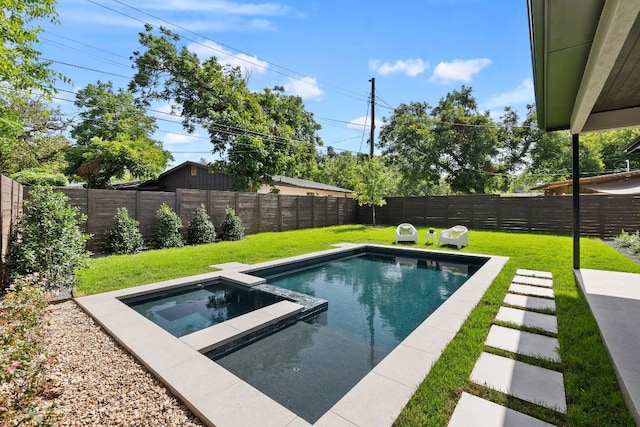 view of swimming pool with a yard and an in ground hot tub