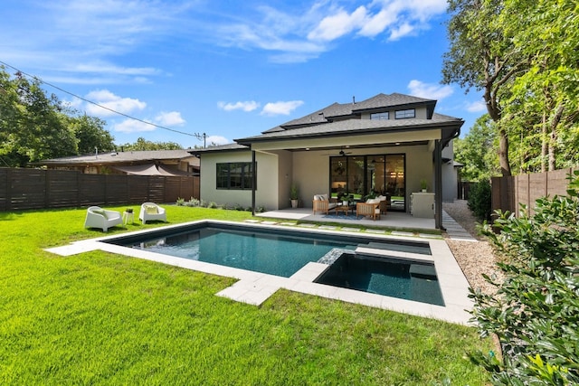 back of house with a lawn, an outdoor hangout area, ceiling fan, a fenced in pool, and a patio area