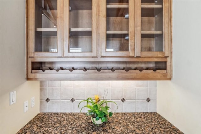 kitchen featuring dark stone countertops and decorative backsplash