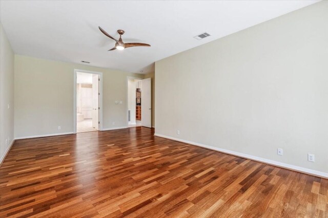 empty room with wood-type flooring and ceiling fan