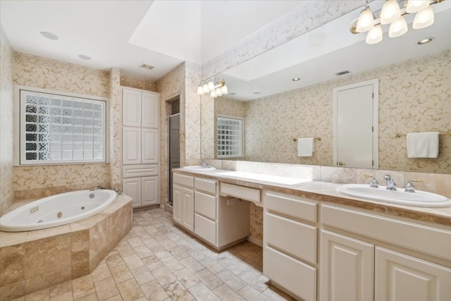 bathroom featuring tiled bath, tile patterned floors, and double sink vanity