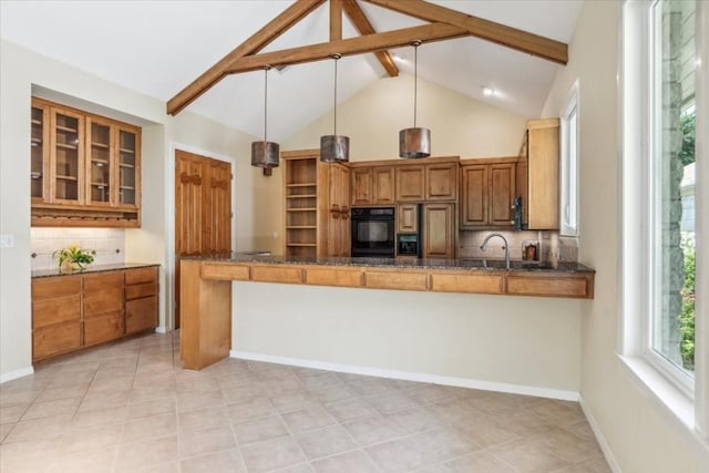 kitchen featuring light tile patterned flooring, beam ceiling, hanging light fixtures, and tasteful backsplash