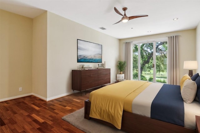 bedroom with dark hardwood / wood-style flooring and ceiling fan