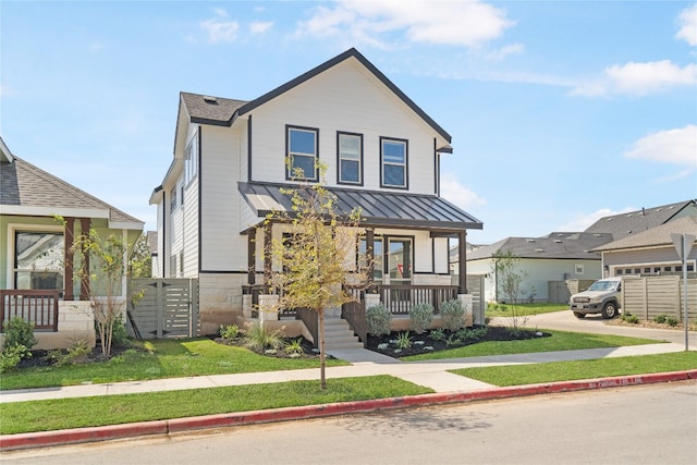 view of front of home featuring covered porch and a front yard