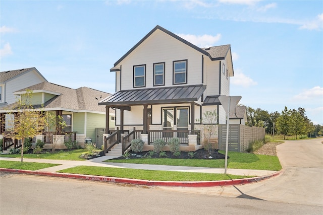 view of front of house featuring a front lawn and covered porch