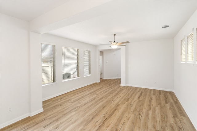 empty room featuring ceiling fan, light hardwood / wood-style flooring, and plenty of natural light