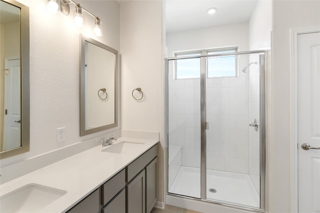 bathroom featuring vanity and a shower with shower door