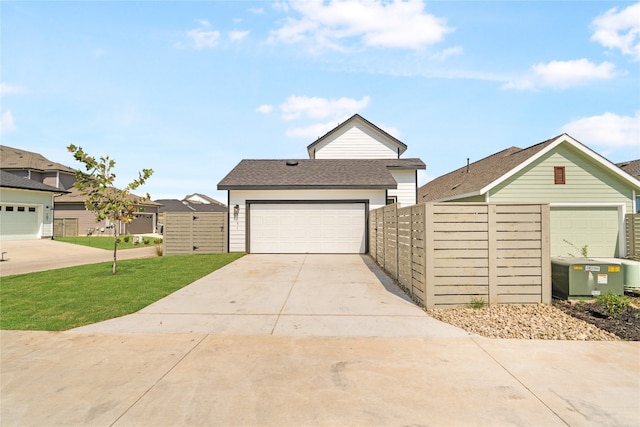 view of front of property with a garage and a front lawn