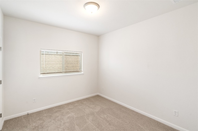 unfurnished room with light carpet