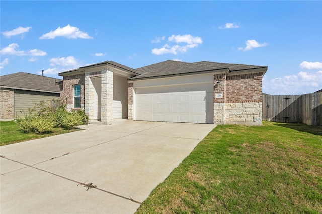 view of front of home featuring a garage and a front lawn