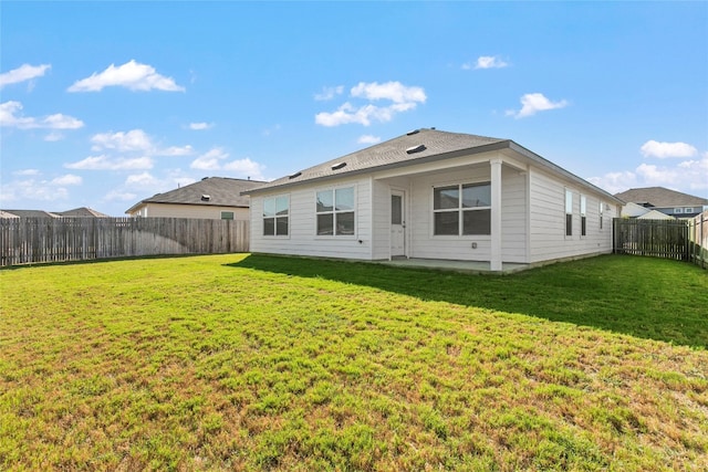 back of property featuring a yard