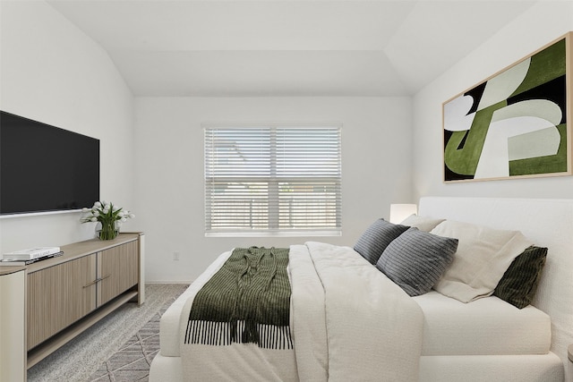 carpeted bedroom with vaulted ceiling