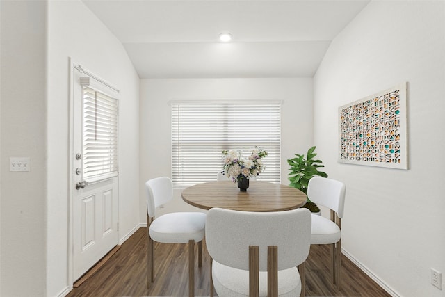 dining space featuring dark hardwood / wood-style flooring and lofted ceiling