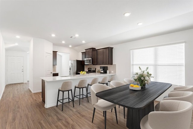 dining space with sink and light wood-type flooring