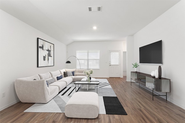 living room featuring lofted ceiling and dark wood-type flooring