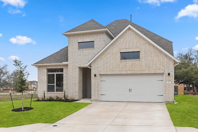 view of front of home featuring a garage and a front yard