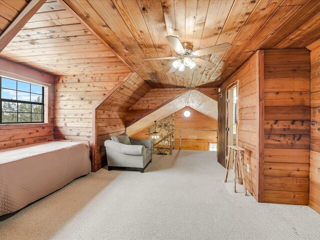 interior space featuring lofted ceiling, wooden walls, and wood ceiling