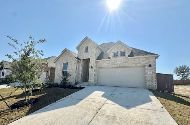 view of front of house featuring a garage and a front lawn