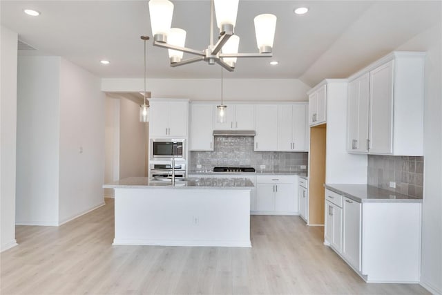 247 Du Bois Ln, Kyle, TX 78640 - kitchen featuring light wood-type flooring, stainless steel appliances, an island with sink, and white cabinets