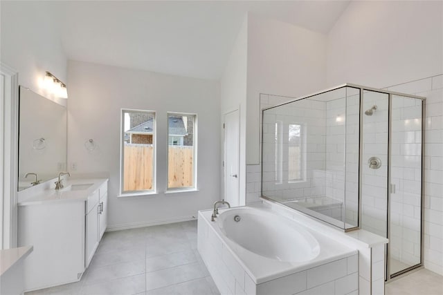 247 Du Bois Ln, Kyle, TX 78640 - bathroom featuring tile patterned flooring, a shower stall, baseboards, a bath, and vanity