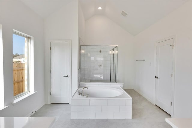 247 Du Bois Ln, Kyle, TX 78640 - bathroom with a stall shower, baseboards, a garden tub, and vaulted ceiling