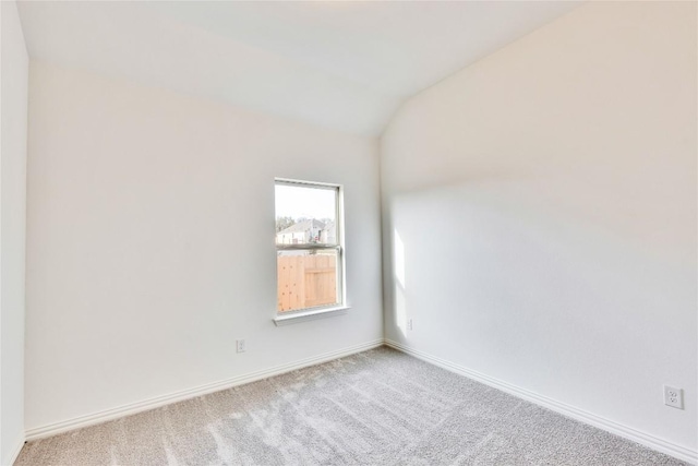 247 Du Bois Ln, Kyle, TX 78640 - carpeted spare room with baseboards and vaulted ceiling