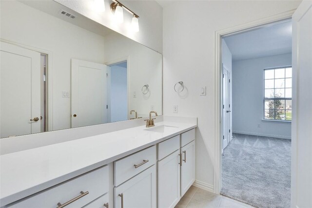 247 Du Bois Ln, Kyle, TX 78640 - bathroom featuring tile patterned floors, visible vents, vanity, and baseboards