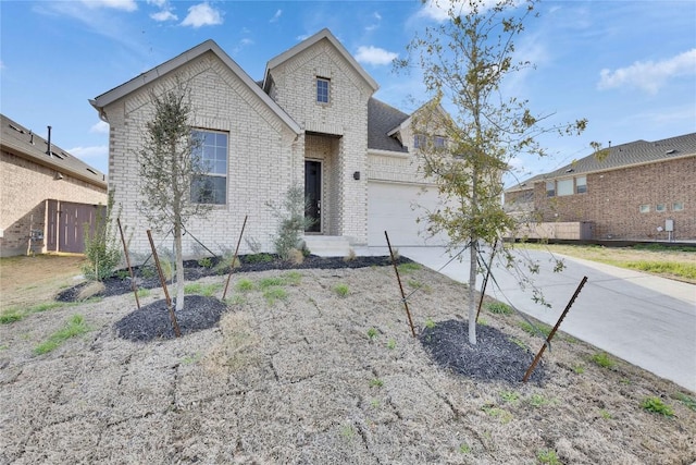 247 Du Bois Ln, Kyle, TX 78640 - traditional home with a garage, brick siding, and concrete driveway