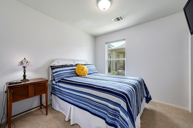 bedroom with light colored carpet