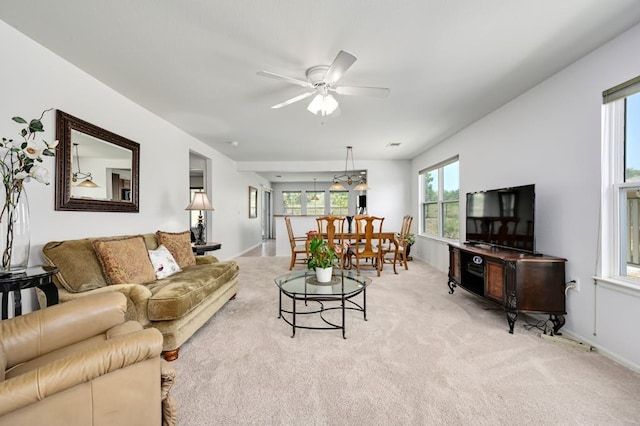 carpeted living room with ceiling fan