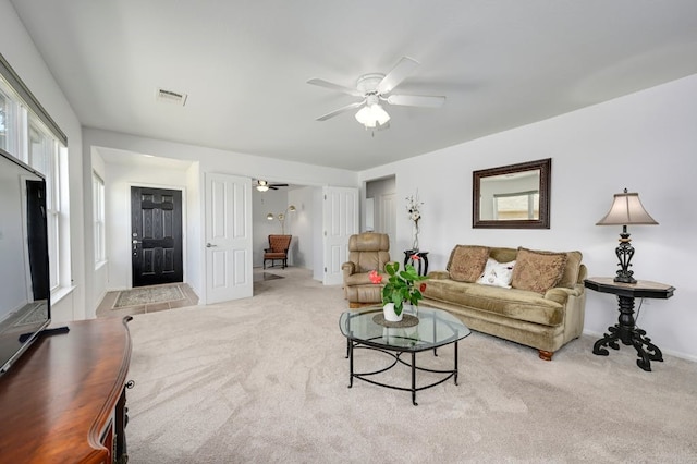 carpeted living room with ceiling fan