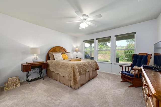 bedroom with light carpet and ceiling fan