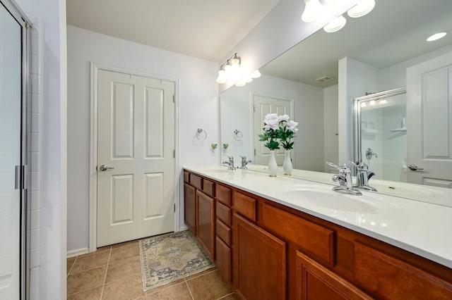 bathroom with tile patterned flooring and dual bowl vanity