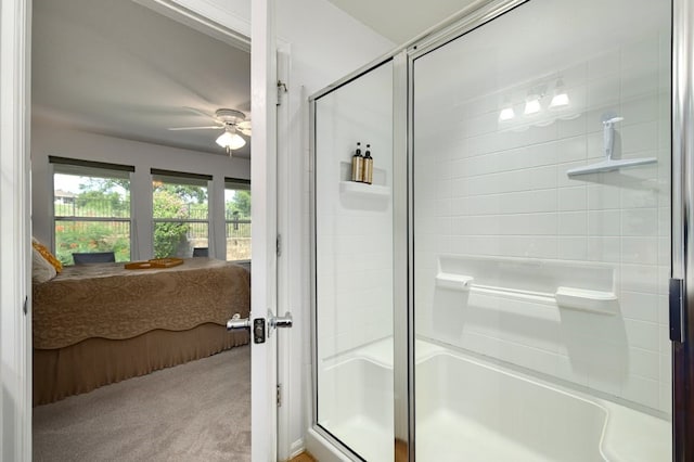 bathroom featuring a shower with door and ceiling fan