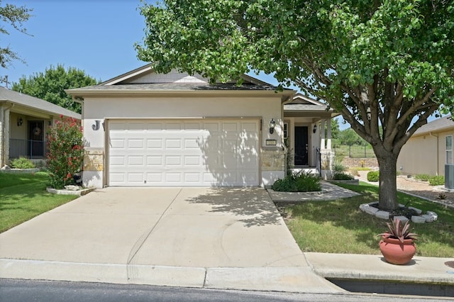 view of front of property featuring a garage and a front lawn